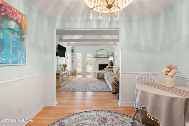7813 Delightful Way, Louisville, KY 40291 - living area featuring wood finished floors, a chandelier, beam ceiling, and wainscoting