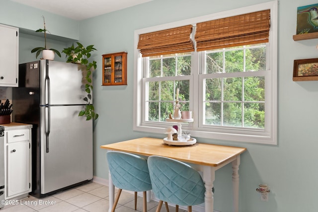 7813 Delightful Way, Louisville, KY 40291 - kitchen with freestanding refrigerator, white cabinets, healthy amount of natural light, and light tile patterned floors