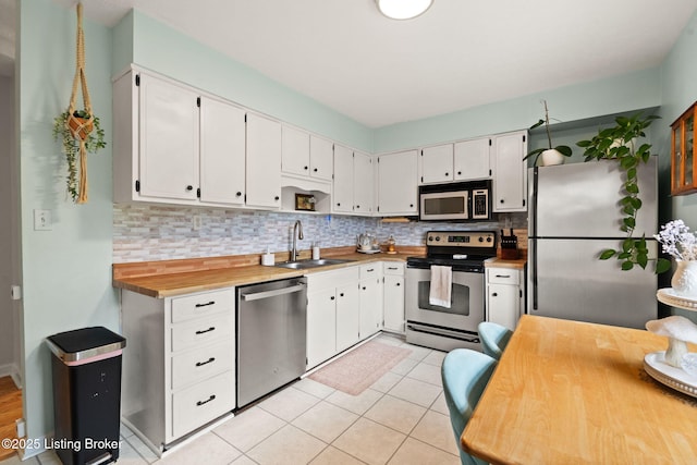 7813 Delightful Way, Louisville, KY 40291 - kitchen with stainless steel appliances, backsplash, white cabinets, and light tile patterned flooring