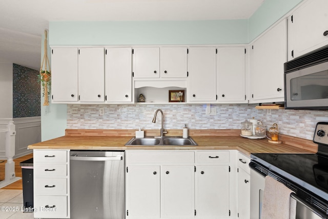 7813 Delightful Way, Louisville, KY 40291 - kitchen featuring appliances with stainless steel finishes, white cabinetry, light countertops, backsplash, and a wainscoted wall