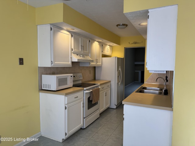 487 Piping Rock Rd, Brandenburg, KY 40108 - kitchen with white appliances, under cabinet range hood, decorative backsplash, and light tile patterned floors