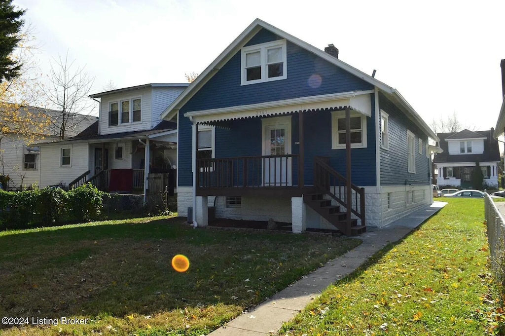 2309 Hale Ave, Louisville, KY 40210 - bungalow-style home featuring a porch, a chimney, a front lawn, and stairway