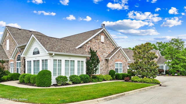 4331 Ivy Crest Cir, Louisville, KY 40241 - traditional home featuring stone siding, a front yard, and a shingled roof