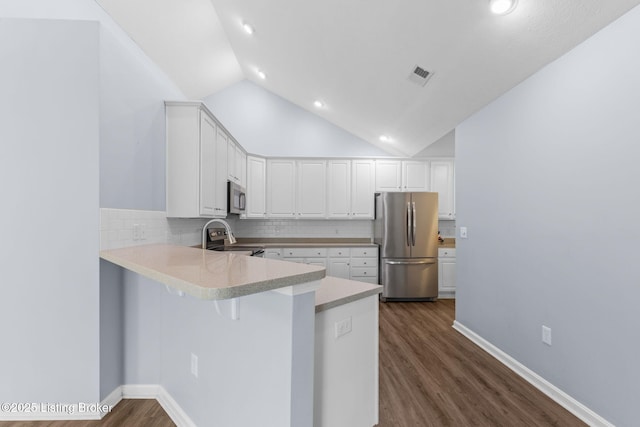 4331 Ivy Crest Cir, Louisville, KY 40241 - kitchen featuring stainless steel appliances, a peninsula, tasteful backsplash, white cabinetry, and lofted ceiling
