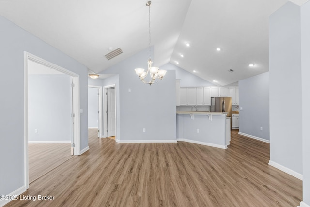 4331 Ivy Crest Cir, Louisville, KY 40241 - unfurnished living room featuring a chandelier, light wood finished floors, recessed lighting, and high vaulted ceiling