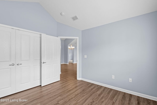 4331 Ivy Crest Cir, Louisville, KY 40241 - unfurnished bedroom featuring a chandelier, wood finished floors, lofted ceiling, and a closet