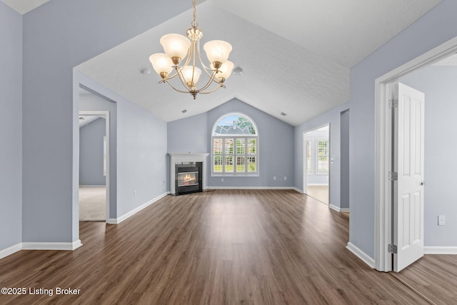 4331 Ivy Crest Cir, Louisville, KY 40241 - unfurnished living room featuring lofted ceiling, dark wood finished floors, a chandelier, and a glass covered fireplace