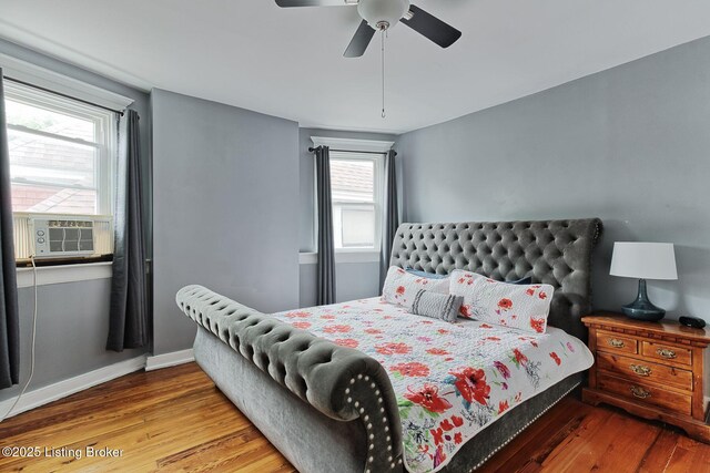 1331 Highland Ave, Louisville, KY 40204 - bedroom featuring wood finished floors, cooling unit, and multiple windows