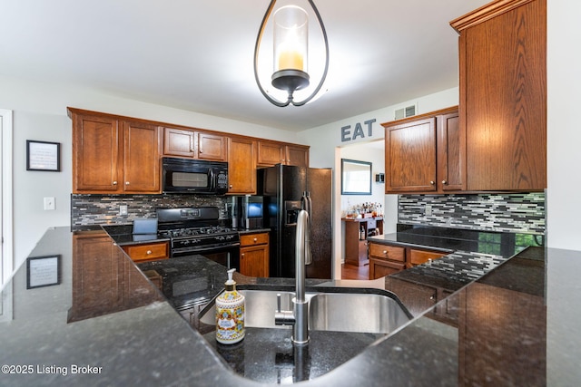 17804 Birch Bend Cir, Fisherville, KY 40023 - kitchen with black appliances, decorative backsplash, dark stone countertops, and brown cabinetry