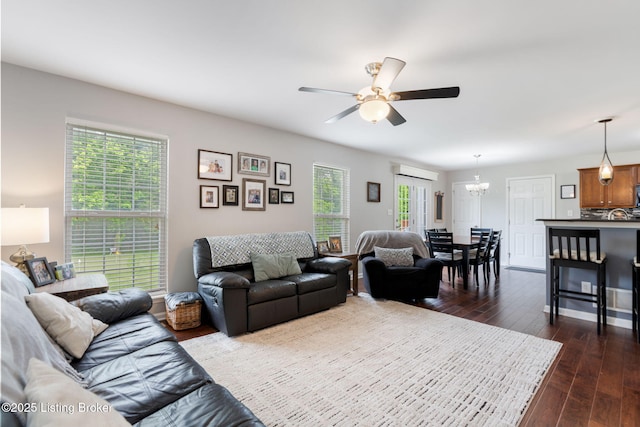 17804 Birch Bend Cir, Fisherville, KY 40023 - living room with a chandelier, a ceiling fan, a wall mounted AC, and dark wood finished floors
