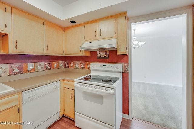 161 Thierman Ln Apt 1E, Louisville, KY 40207 - kitchen with under cabinet range hood, white appliances, light countertops, and a chandelier
