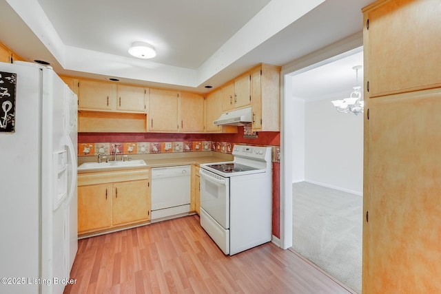 161 Thierman Ln Apt 1E, Louisville, KY 40207 - kitchen featuring white appliances, under cabinet range hood, a chandelier, light countertops, and light wood finished floors