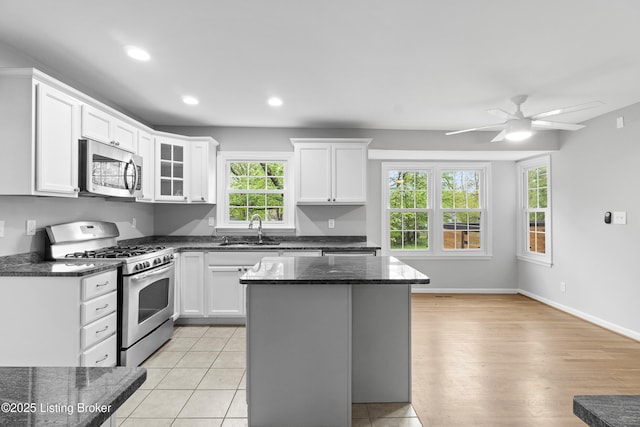 1908 Landing Rd, Prospect, KY 40059 - kitchen featuring appliances with stainless steel finishes, white cabinets, ceiling fan, a center island, and recessed lighting