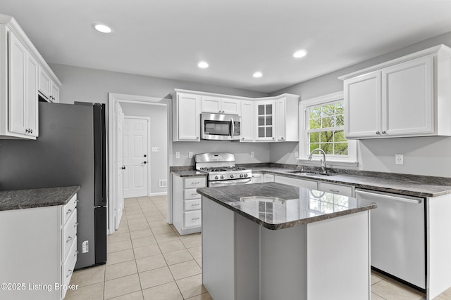 1908 Landing Rd, Prospect, KY 40059 - kitchen featuring stainless steel appliances, white cabinets, recessed lighting, light tile patterned floors, and a kitchen island