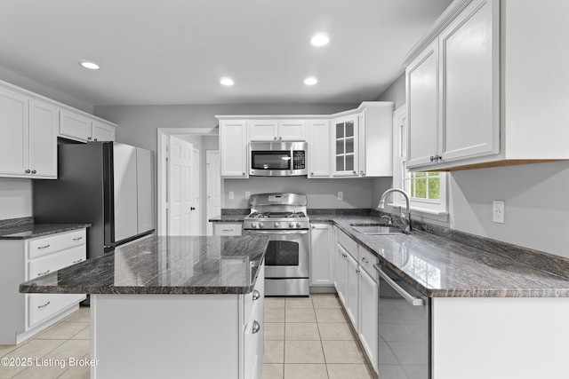 1908 Landing Rd, Prospect, KY 40059 - kitchen with stainless steel appliances, recessed lighting, white cabinets, a kitchen island, and light tile patterned floors