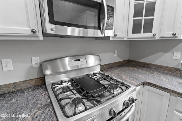 1908 Landing Rd, Prospect, KY 40059 - kitchen view of gas stove, stainless steel microwave, white cabinetry, and glass insert cabinets