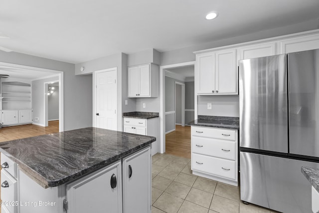 1908 Landing Rd, Prospect, KY 40059 - kitchen with freestanding refrigerator, white cabinetry, dark stone counters, recessed lighting, and light tile patterned floors