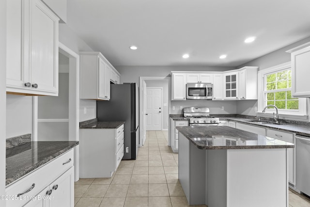 1908 Landing Rd, Prospect, KY 40059 - kitchen featuring appliances with stainless steel finishes, white cabinets, recessed lighting, a kitchen island, and dark stone counters