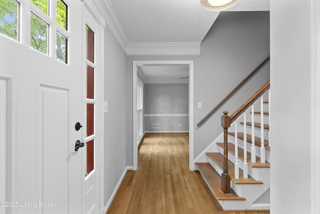 1908 Landing Rd, Prospect, KY 40059 - entrance foyer featuring wood finished floors, stairs, ornamental molding, and a textured ceiling