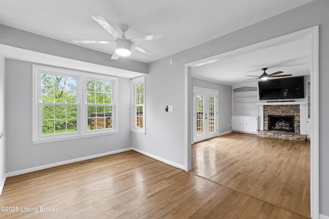 1908 Landing Rd, Prospect, KY 40059 - unfurnished living room with a ceiling fan, wood finished floors, french doors, and a stone fireplace