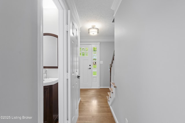 1908 Landing Rd, Prospect, KY 40059 - corridor featuring light wood-style flooring, stairs, a textured ceiling, and ornamental molding