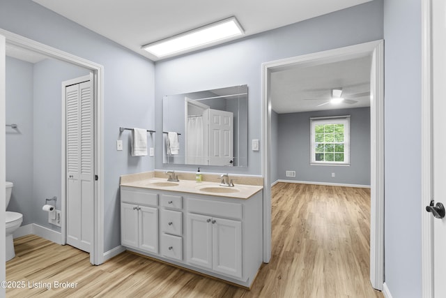 1908 Landing Rd, Prospect, KY 40059 - bathroom with double vanity, a closet, wood finished floors, and ceiling fan