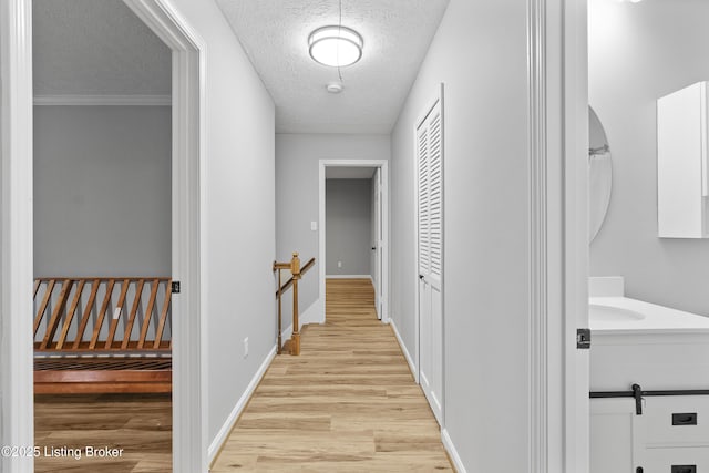 1908 Landing Rd, Prospect, KY 40059 - hall with light wood-style floors, a textured ceiling, and an upstairs landing