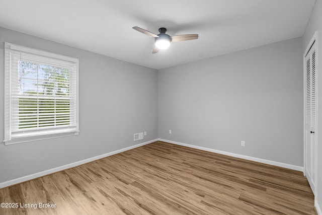 1908 Landing Rd, Prospect, KY 40059 - unfurnished bedroom with wood finished floors, a closet, and a ceiling fan