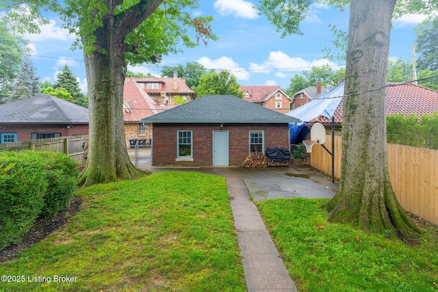 2144 Baringer Ave, Louisville, KY 40204 - rear view of property featuring a fenced backyard, brick siding, a patio, and roof with shingles