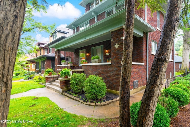2144 Baringer Ave, Louisville, KY 40204 - view of front of property featuring brick siding and covered porch