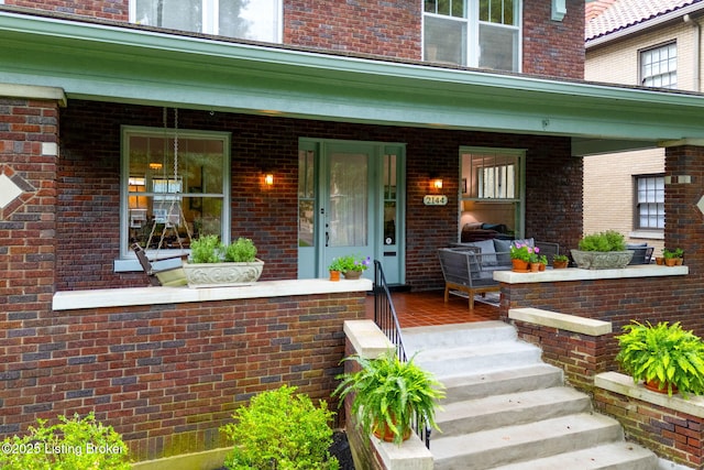 2144 Baringer Ave, Louisville, KY 40204 - doorway to property featuring covered porch and brick siding
