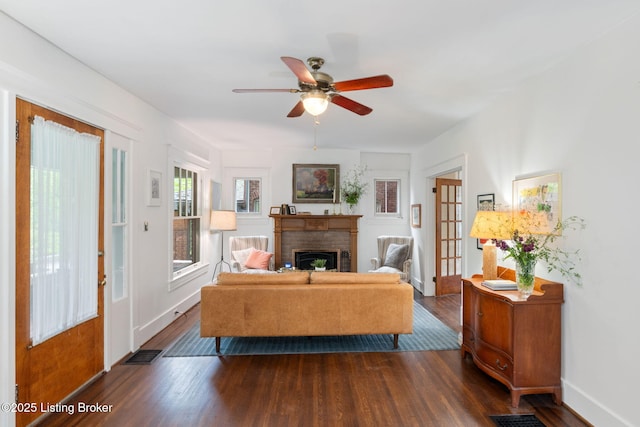 2144 Baringer Ave, Louisville, KY 40204 - living area with dark wood-type flooring, a ceiling fan, and a brick fireplace