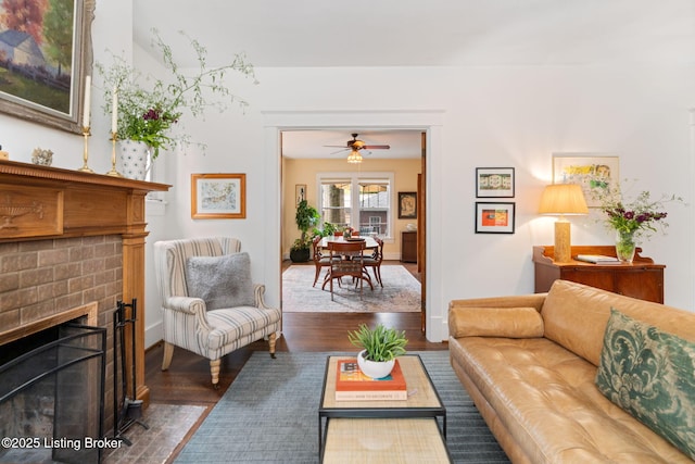 2144 Baringer Ave, Louisville, KY 40204 - living room with wood finished floors, a ceiling fan, and a brick fireplace