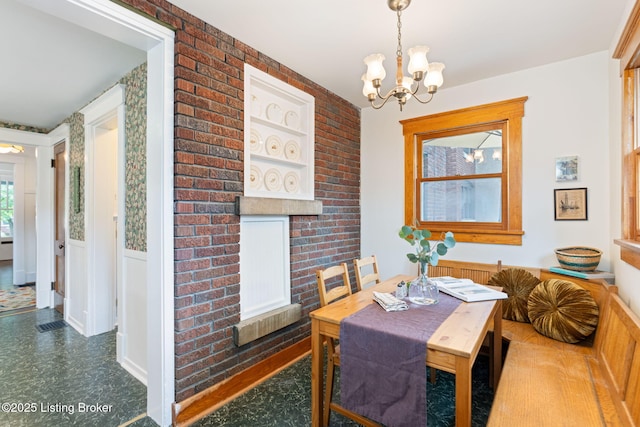 2144 Baringer Ave, Louisville, KY 40204 - dining room featuring a chandelier, a wainscoted wall, and tile patterned floors