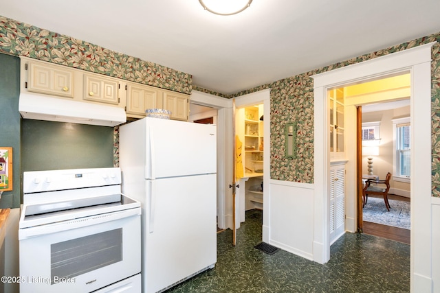2144 Baringer Ave, Louisville, KY 40204 - kitchen featuring white appliances, under cabinet range hood, dark floors, a wainscoted wall, and cream cabinetry