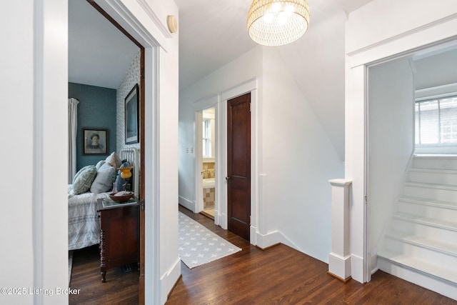 2144 Baringer Ave, Louisville, KY 40204 - hallway with a chandelier, wood finished floors, and stairs