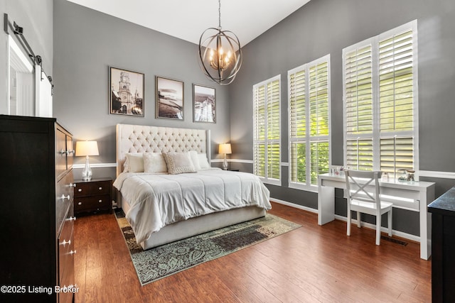 3903 Zaring Mill Ct, Louisville, KY 40241 - bedroom with a barn door, a chandelier, and wood finished floors