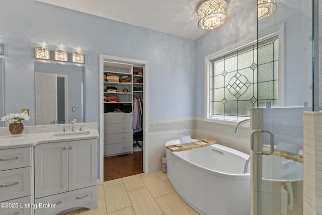 3903 Zaring Mill Ct, Louisville, KY 40241 - full bath with vanity, a walk in closet, a freestanding bath, and tile walls
