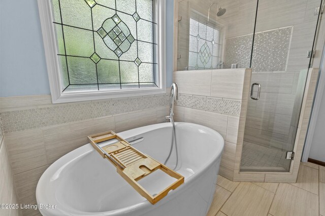 3903 Zaring Mill Ct, Louisville, KY 40241 - full bath featuring healthy amount of natural light, a stall shower, a freestanding bath, and tile walls