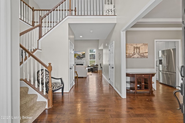 3903 Zaring Mill Ct, Louisville, KY 40241 - foyer featuring wood-type flooring, stairway, a high ceiling, crown molding, and a fireplace