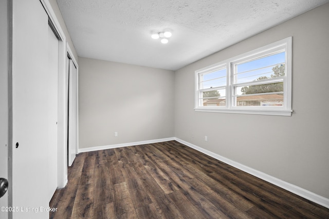 6218 Helenjean Way, Louisville, KY 40272 - unfurnished bedroom featuring a closet, dark wood-style floors, and a textured ceiling