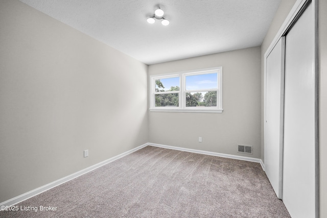 6218 Helenjean Way, Louisville, KY 40272 - unfurnished bedroom featuring carpet, a closet, and a textured ceiling
