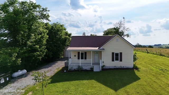 6099 Bloomfield Rd, Springfield, KY 40069 - view of front of house with covered porch, a front lawn, a metal roof, and driveway