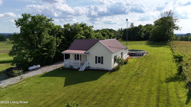 6099 Bloomfield Rd, Springfield, KY 40069 - view of front facade featuring covered porch, a front yard, and a metal roof