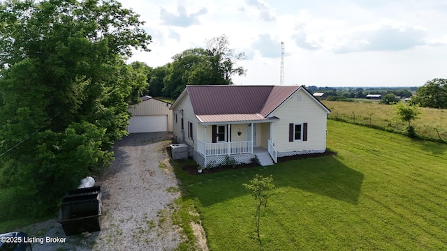 6099 Bloomfield Rd, Springfield, KY 40069 - farmhouse featuring covered porch, an outdoor structure, a front lawn, and a metal roof