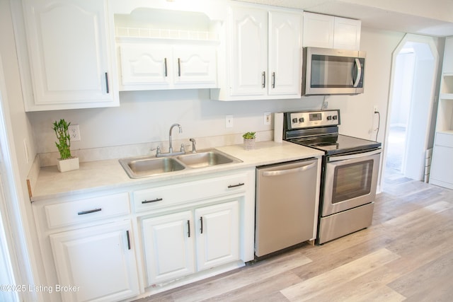 6099 Bloomfield Rd, Springfield, KY 40069 - kitchen with appliances with stainless steel finishes, white cabinets, light wood-style flooring, and light countertops