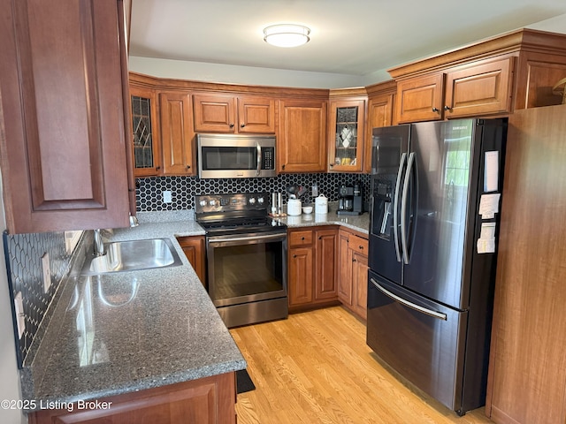 117 Deep Springs Dr, Bardstown, KY 40004 - kitchen with appliances with stainless steel finishes, brown cabinetry, light wood-type flooring, and glass insert cabinets