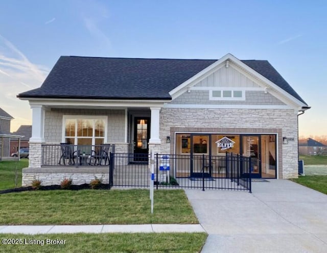 15958 Cumberland Lake Cir, Louisville, KY 40245 - craftsman house with stone siding, a porch, a lawn, and a shingled roof