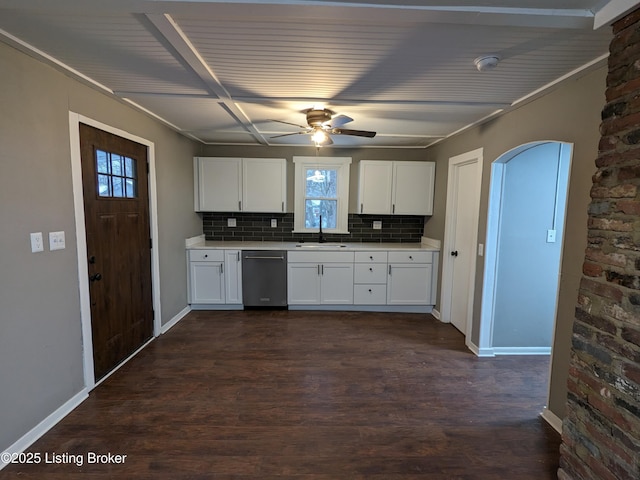 4100 Puppers Ct, Louisville, KY 40213 - kitchen with stainless steel dishwasher, backsplash, dark wood-style flooring, white cabinets, and a ceiling fan