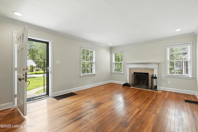 335 Ridgeway Ave, Louisville, KY 40207 - unfurnished living room featuring ornamental molding, hardwood / wood-style flooring, a fireplace, and recessed lighting